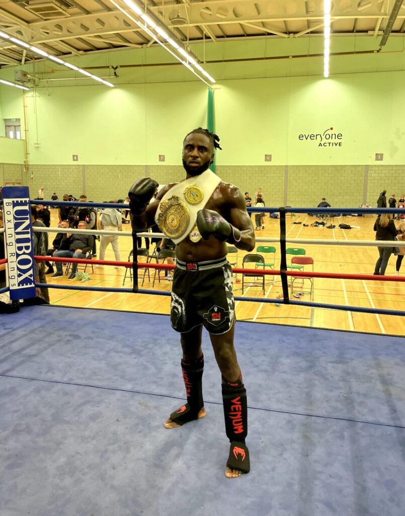 Samuel holding his world title belt