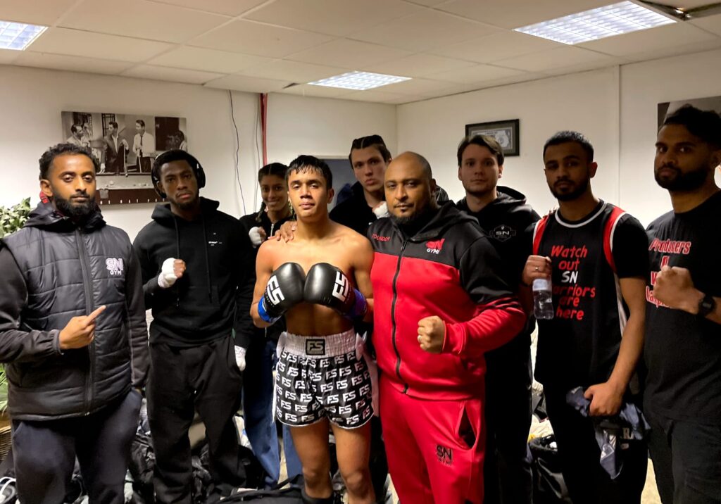 Anas Khan with his headcoach and SN Combat Academy team