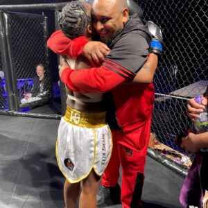 Elia gives headcoach Khru Sam a hug after final fight of her career