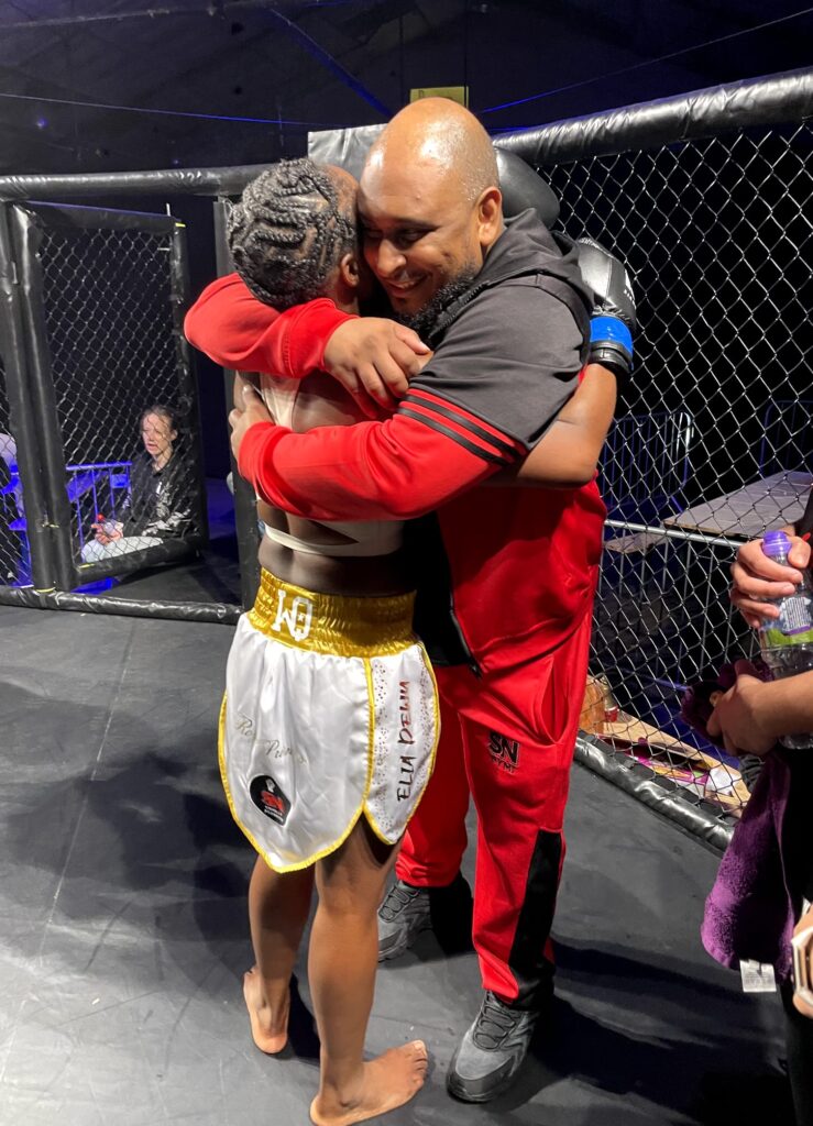 Elia gives headcoach Khru Sam a hug after final fight of her career