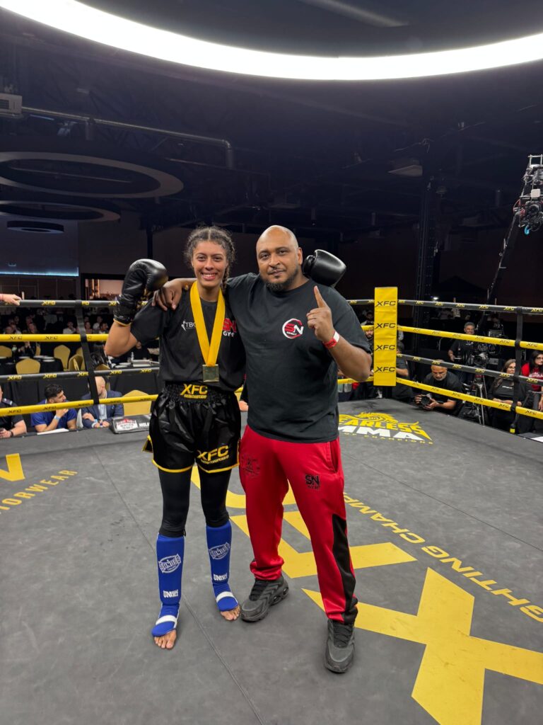 Yasmin Cleanheart Ahmed winner at the XFC Fighting Championships in Birmingham with headcoach Khru Sam Nankani