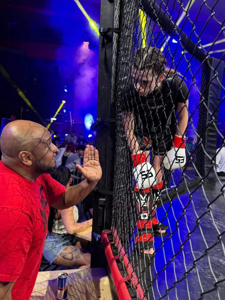 Summer being coached during fight by Khru sam Nankani