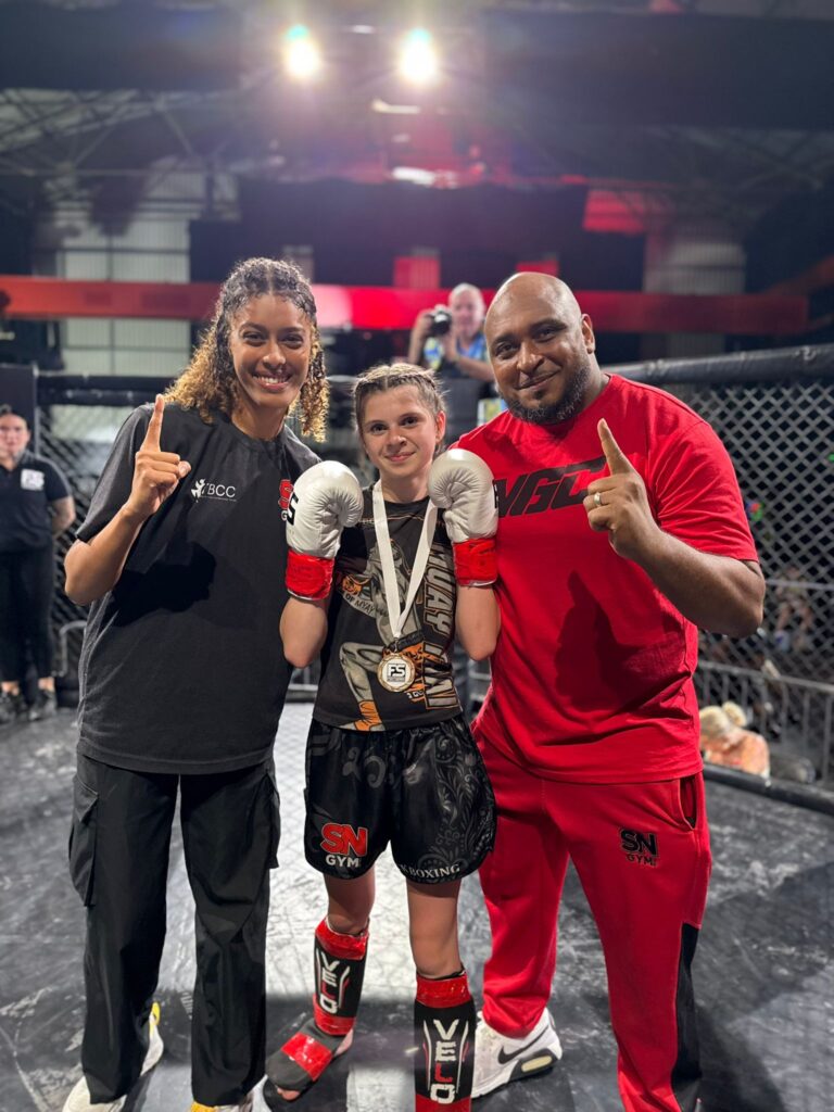 Summer Sawyer after victory in her K1 debut with headcoach Khru Sam Nankani and team mate Yasmin Ahmed