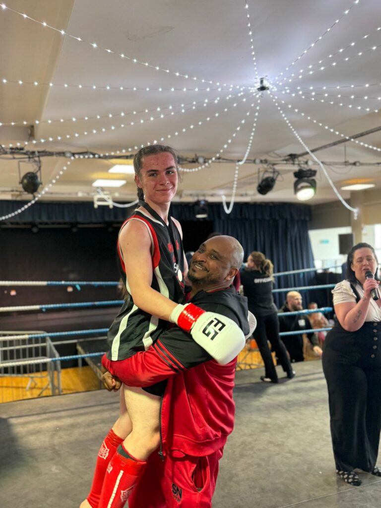 Callum Sawyer celebrating his win with headcoach Khru Sam Nankani