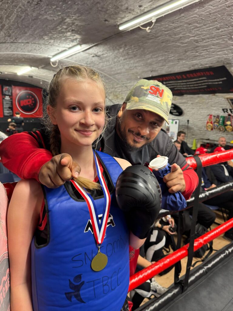 Legendary and current England Ring Sport headcoach Khru Sam Nankani with student after fight